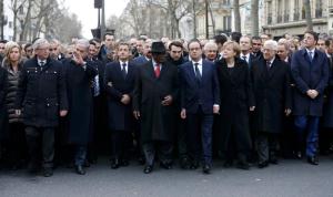 French President Hollande is surrounded by head of states as they attend the solidarity march in the streets of Paris